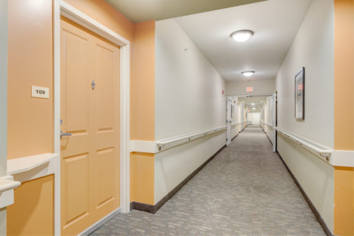 long hallway with orange door